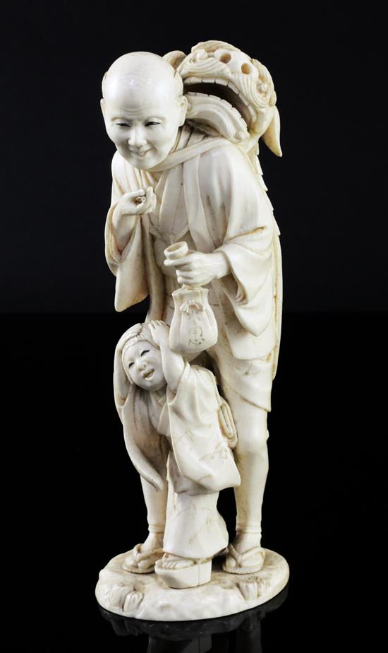 A Japanese ivory group of a shi-shi dancer and a boy, Meiji period, 17.5cm
